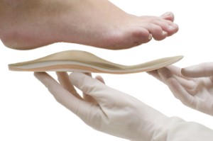 A new clinical study has demonstrated that orthotic devices worn on the feet can have whole-body benefits that can help to reduce back pain. Image credit: zilli via iStock